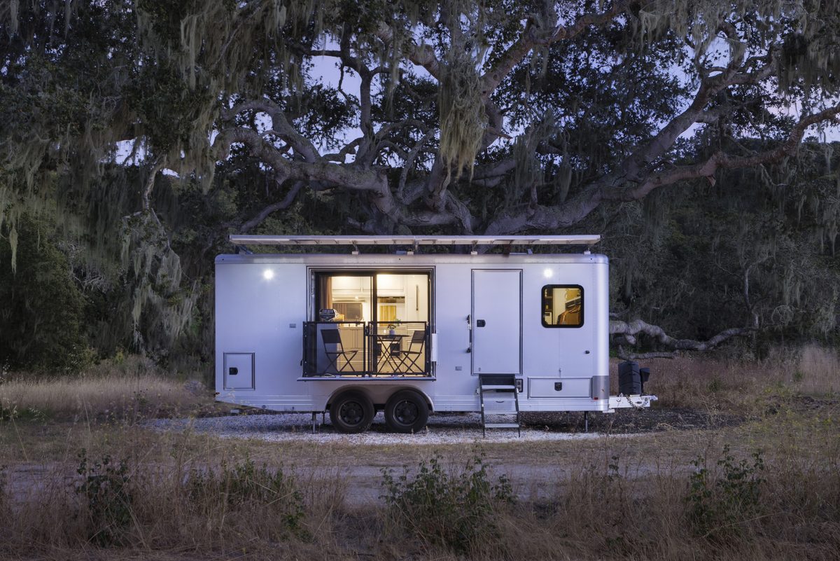 A Living Vehicle HD24 at dusk under a large oak tree